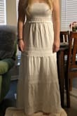 I thought this dress would be nicer based on the price. I ordered it for my bridal shower, but it looks more like a sundress than a shower dress. I am usually a large but since the top wasn't fitted, I ordered a medium. The medium fit perfectly. If it cost less I would've kept it to wear as a sun dress or on our honeymoon, but it's too casual for the price. I wore nude undergarments and didn't fit it to be see through but the material was kind of thin. - Caroline K.