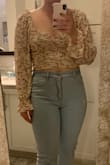 This shirt was so cute! It was exactly as pictured, and the material was what I expected from this type of ruched top. It is definitely cropped, and ultimately didn't flatter me being a little fuller and taller. I normally wear a medium or large and don't think I would've sized up, it would have been too baggy. Loved the concept and the quality was good. - Abbey M.