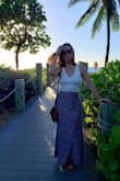 I bought this skirt for vacation and it didn't disappoint! The print is vibrant and beautiful in person and the material is comfortable and flowy. The slit goes a little high but as long as you're not in heavy winds it's a nonissue.
Bought a small which fit mostly TTS though the waist is on the snug side. I'm 5'3" with short legs and this hung just off the ground with no alterations needed. - Carrie M.