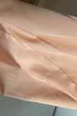 Very disappointed with the colour of this dress. It is MUCH more pink in person. The fabric seems to be good quality and fit is fine but the colour is nowhere near "champagne", it's a peachy-pink. My review photo was taken in natural lighting to better show the colour. This would probably be beautiful if you have a deeper, warm skin tone but it is still not really 'champagne'. - Briannah D.
