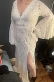 I bought this dress after reading all the amazing reviews on it. It's stunning in person and fits all my hopes for a wedding dress. If you are on the fence, just buy it!! It's amazing. I normally wear a L/XL but I sized up a 1X because I was worried it might be a little too tight in the tummy area. It's very flattering and I am still going to buy undergarments because of my own chosing not because of the dress. Like the others reviews, I am planning to get the slit sew into the dress and get it hemmed but otherwise, I wouldn't change a thing! - Kristen B.