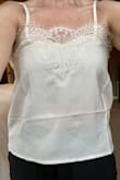 I purchased this cami to wear under sweaters and jackets. I also planned to wear by itself in warm weather. I'm returning because it can't be worn by itself. It has a square boxy shape that bulged out at my waist and made me look wide. It is thin and denim pants show through the shirt. The lace is pretty, but I would spend maybe $20 on it. I have washable silk camis at this price that were higher quality and had a more flattering fit. - Brianne M.