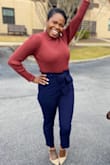 This rust color is everything! The sweater is of good quality and a perfect balance between thin & thick sweaters! It can totally be worn tucked in or left out! It was fitted to show curves but not tight at all. The sleeves were a little long but nothing a cuff didn't fix. - Makeda W.