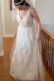 I liked this dress; it felt very royal, especially with a pearl necklace and tiara veil! It isn't a very sexy dress, good for if you want something more conservative. I didn't feel like it was very flattering on me though, made my frame look a bit rectangular. I also wish the lace bottom layer was above the netted layer. - Mackenzie C.