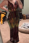 In the pictures on here, I thought it would be more burgundy but the sequins are more red and orange. I liked the way it looked but I wish it was tighter in my back. It fit good everywhere except my back- it looked loose. - Katelynne R.