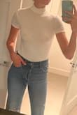 Everyone needs a simple white top in their closet! This one is pretty thin so you may want to wear a bra with it. I'm more of a free the nipple gal so I just wear it as is. It's not as long as I hoped but still tucks into my jeans. Overall a good top!! - Kellyn S.