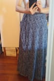 Runs a little small, fits tight. I typically wear 0-2. If you are this size, I'd choose S over XS. 
Short ladies, FYI it's long, definitely picks up dirt on the ground if I'm barefoot or wear sandals. 
Also, mine may be sewn wrong but there's a portion of the skirt at the slit that just sticks out. See picture. Contemplating returning it. - Lily Z.