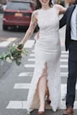 If you are at all considering this dress and this style, order it! If it's not the right one, returns are easy. The price of this dress gave me room in my budget to splurge on other accessories and flowers for my elopement. I'm normally a medium but it was sold out, so I decided to try the small after seeing another reviewer say she wore a small while 5 months pregnant. Fit like a glove.
I altered it slightly by having the lining attached to the shell along the front slit. I also tried to have a bustle installed but the train is too heavy for it to work. A tailor more experienced in gowns might be able to figure it out. I would choose this dress again 100 times over. - Moo S.