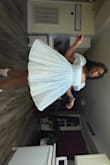 I ordered this dress to wear to an Alice in Wonderland themed bar pop-up and I loved it! I ordered a medium but definitely should've gotten a small! I was concerned with the no-stretch material but could've gotten away with a smaller size for sure! I got so many compliments on this. Must buy! (I did wear a petticoat underneath for a little more flare!) - Taylor J.