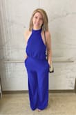 I love this jumpsuit, first off it has [a] pocket. Need I say more? The color is so gorgeous. The neckline is super flattering and the low back shows just the right amount of skin. I'm 5'4 and even with 3.5" heels I still had to hem the legs up a few inches. So if you're on the taller side you should be just fine there. I'm also larger chested and ended up being able to wear a little boob tape and was fine. The only thing I will say is to add a little double-sided tape around the chest - Danielle G.