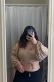This is such a cute top, perfect for a disco-themed party, new years, or any event to stand out. Tight and flattering around the chest and looser in the arms. The ties in the middle allow for more modest or ruched chest line. - Lauren F.