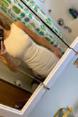 Love this dress! It's a thicker material so it doesn't show too much. The low back has boning to keep it in place. Midi length is too long for flats but looks good with heels. Got it for my rehearsal dinner and it might be a bit much for that but keeping it for a fancy dinner out with my hubby! - Michaela O.
