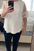 I bought this to wear to my bridal shower. It runs small across the chest and shoulders and the medium was too small. The large was sold out so I bought XL which is a little big on me, but the blouse is nice and flowy that I decided to keep it. The lace detail on the sleeve is really pretty and the blouse is lined so its not see through. - Marie J.