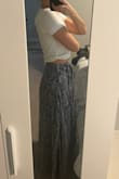 This skirt does not wrap. It has a side zipper and the waist measures 11 inches (if only I had a 22 in waist LOL). I am usually a small but ordered an XS because I thought it was adjustable as a wrap skirt. I really had to suck it in order to get the zipper as high as I did! The length was good on me so I worry that the small would be too long. The skirt is flowy and the slip doesn't reveal too much. I'm sure it's a great skirt for those it fits :) - Alexandra B.