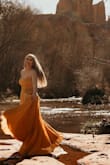 I just returned from vacationing in Sedona Arizona and chose this stunning dress to be photographed in a boudoir session among the red rock. The color couldn't be more perfect in that setting. At first I ordered a large but it was swimming on me so I exchanged for a medium which with a few strap adjustments it fit perfectly. I wore a stick on bra to hold my self in as I didn't want side boob showing. My pictures turned out incredible. Pic by Sedona Bella in Chapel Rock at red stone pass. I am 52, I weigh 135 with a very curvy hourglass shape and 36D, the medium fit perfectly y 4.5 stilettos. - Judith D.