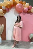 I had been on the hunt for what felt like MONTHS looking for the perfect baby shower dress from all of my usual online boutiques (including Lulus, actually) to no avail, I just couldn't find "the one." Should've known Lulus would eventually save the day! This cutie came up one day while I was on the hunt and I ordered both a large and x-large to accommodate for any body changes since I was going to be 33 weeks pregnant at the time of shower and the large worked perfectly. For reference, I'd usually wear a medium pre-pregnancy, but since being pregnant, I've found that larges are the comfiest as I have put a little weight on here and there. I have a larger chest that actually hasn't changed much during pregnancy, but after reading the other reviews (after I ordered of course, ugh) I was nervous that the bust would be roomy. Thankfully that wasn't a problem I encountered, it fit perfectly without being uncomfortably tight anywhere OR having extra fabric anywhere. Totally bump-friendly and was super cute!! - Kaitlyn M.