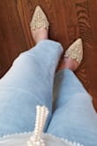 I adore these shoes and ordered a backup pair. They fit true to the size I typically order (7.5). I haven't had a problem with any of the stones popping off, but I've only worn them a few times. I've worn them with jeans as well as a date-night dress and love them with everything. - Rachel V.