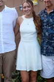 I wore this dress to my outdoor engagement party and received so many compliments. It's fun and flirty with the open back but also classy with the mock neck. Worked great with an up-do for the heat of summer! - Anna M.
