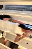 I purchased both the small and medium because I am on the cusp of the two sizes. I ended up going with the medium. It does run a little small in my opinion, but the right undergarments helped! Photo is without undergarments. - Ashley D.