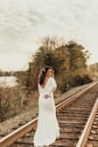 I tried SO many dresses at all price points for our big day, but I kept coming back to this dress. I wanted long sleeves for our March wedding and the buttons down the back were just an added plus. I typically wear a size 8 in pants but ordered a large In the dress due to my bait size. I probably could have gone with a medium as the fabric is stretchy. I received so many compliments on this dress! - Casey P.