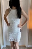 I found this dress while looking for a white dress for our daughter's graduation. She loves flowers and most crocheted things, so I gave it a shot. I knew her normal size since we shop Lulus often. I purchased her an XS and it was perfect. Not too loose and not so tight that it causes creasing or the fabric to roll. It hugs her like a glove, but not inappropriately. It is an amazing dress. You can't go wrong. I'll probably purchase it for her in other colors as well, but she wanted white for her high school graduation. I think this dress in different colors would be perfect for so many spring and summer events coming up. Don't mind the sports bra strap underneath in the pics.= She was just trying it on. Graduation hasn't happened yet. The pics are cropped because it wouldn't let me expand the pics, but you get the idea. Buy the dress! - Mildred Y.