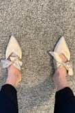 These fit okay, run slightly narrow.  They are flat so pretty comfy, but they look kind of goofy on my feet, I thought.  The bows don't lay quite like they do in the photo.  The worst though is the creases that show in the pointed part and the fact that they are CHAMPAGNE, not ivory, so they would not match many ivory wedding dresses if you were looking for true ivory. - Lizzy C.