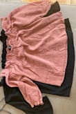 I bought the same shirt in black in a small (which I love) but they fit entirely differently! The pink was like a baby crop top. See pics for how massive the discrepancy is. Super disappointed so I had to return. If it was cut the same as the black I would have kept it. The fabric and quality otherwise were great and perfect for warmer temps. - Molly E.