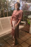 The dress fit is true to size. I ordered two sizes because I was not sure.... the Material is soft and flows and feels really good. Great dress for dancing and a sexy classy feeling. - Margo S.