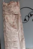 The dress is beautiful and so elegant! It is fully lined. My daughter loved it. The top fits perfectly but the bottom is a bit loose on the hips and also too long - will have to have it tailored. A bra is not necessary either because it offers support unless you are a bit heavy on top.
The fabric is thick and stiff as it looks on the model-which is what we were expecting. The colors of the embroidery are a mix of pink and metallics silver and gold.
The bow is a beautiful detail on the dress but it will be important to learn how to tie a nice bow instead of just the regular one I can tie.
I'm happy with this dress just what we were looking for. - Raquel M.