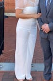 Perfect fit and didn't have any issues with the strapless top falling down due to the stretch. which was nice. Also was nice that it was long enough in the torso as most jumpsuits are too short for tall gals like me. Wore with a sheer wrap top for my courthouse wedding, was really comfy. - Noelle G.