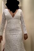 The dress is beautiful, and the color is white. It's not see-through, only on the sleeves. The pattern is different, which I love. The cut in the front and back is like a V shape, which makes you show cleavage (especially for me with medium-size breasts). I'm not wearing a bra or a corset in the pictures, so I can only imagine how better it would look if I did. I was worried about my back rolls showing in this dress, but they don't! The sleeves are too long, so I had to fold them in, as you can see in the picture by my wrists. The length of the dress wasn't too bad for me, especially when wearing heels. The tail is pretty long, but it looks beautiful! - Josselyn M.