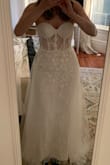 Beautiful, intricate detailing. It's insane that this dress is under $300.
I'm usually in between sizes 4 and 6. Based on reviews I ordered a size 4, but this fabric has zero give. It fit a bit too snugly around my hips and bunched up. I also wasn't able to zip it up fully in the back without help. If I were to reorder again, I would go with the 6. (I'm wearing 2.5" heels in this picture, for reference for my tall friends.)
I was surprised to learn that the skirt does not detach - it is secured on by one of the sequin flowers. So the tulle stays firmly in place. Also, the fabric is pretty decent, but you would definitely need to wear nude underwear with it.
It wasn't quite what I was looking for, so she goes back. However, an absolutely gorgeous dress with fantastic details. Perfect for someone who is looking for something sassy. - Kimberly K.