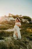 This dress is so beautiful! I thought it would be too long for my 4'11 height but it was perfect. I wore it at my 36 weeks and 6 days maternity shoot and was still able to squeeze into it. - Kamli S.