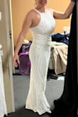 This dress was absolutely gorgeous and of high quality. The beading is amazing and the exact shape I was looking for. I ordered a large because, with my large bust, it is almost always a must. The dress fit well, except there was too much room still in the bust. I would have had to have the sides taken in for sure and maybe even the halter part shortened.  If I had time before my wedding, I would have ordered in a medium just to see if it fit better, but I am worried the hips would be too tight. If it comes in other colors, I will definitely order it again as a dress for me to wear to my stepdaughter's wedding. Probably have it altered.  Really beautiful!! Ps. I am standing on my tip toes in the pics, the dress would have been perfect or slightly long for me at 5' 5 1/2" with heels. - Barbara M.