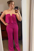 I absolutely love this jumpsuit! It does run very long, but if you're wearing tall heels it works perfectly! It is super comfortable and stays up very well, even with smaller chest size. - Kristin N.