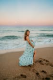 This dress is absolutely beautiful. This dress is more blue than green though. The top fits more loosely but it's adjustable. I wore it for my maternity photoshoot at 36 weeks. I was also surprised it didn't need to be hemmed. - Kamli S.