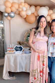 Wore this for my baby shower at 26 weeks and it fit the bump perfectly. pre-bump, I'm a size small but got a size M and it worked out great! I got a lot of compliments. I will say it's a little long, even with small heels it was all the way to the floor but nothing too crazy. - ARACELI V.