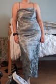 I originally ordered a large because that's my normal Lulus dress size but this dress runs slightly large. Had to return and order a medium instead. The medium fits perfectly but is tighter on my chest so I don't get that cowl neck style the dress should have. If you are midsized or in between 2 sizes the medium will be the best fit but if you want a little more room you should get the large. I normally wear a size 10/12 in pants and large in shirts. There is also little stretch to this dress but the ruching on the stomach hides my stomach pouch. 

The color is gorgeous and the fabric is so soft. Perfect dress for the garden wedding I'm attending in May. - Alyssa P.