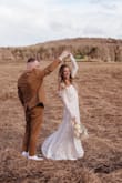 I wore this on my wedding day and loved it. I did have the front hemmed, I am 5'3. I left the back Unhemmed to create a small train. I did not have to have it taken in anywhere else. It was a little annoying to hold up and I did not have a lot of mobility but all in all it was a great dress and an awesome price. - Alexis Z.