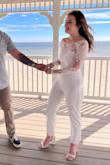 I got this for my legal ceremony and it was perfect! I usually am between sizes with a small and medium because of my hips, but the small was perfect. There's a good amount of stretch which is perfect. There is no stretch in the arms because of the lace, though. So perfect, I loved this jumpsuit! - Sydney D.