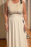 This dress is beyond what I expected. Absolutely beautiful and simple. Made very well. I am 5'3 and will need to have hemmed, it fits perfectly everywhere else. Very please with this dress - Lisa B.