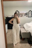 I'm short, so I didn't want to order a L and worry about it being too long! I ordered a M and it's pretty perfect! Still a little long, but I'll be wearing 3" heels. It's also a little tight on the bottom half, but that's because I'm pear-shaped. This also means the top is only slightly loose, again, because of my body shape. I wouldn't change the size I ordered! It's so beautiful and I can't wait to wear it after our wedding to go out downtown. - Julianne D.