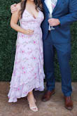 This is a beautiful spring dress. I loved the color and flow. It was long on me and I had to have it hemmed, but I am 5'2". The back has ties so you can adjust it to what you need. You can't see the slit in the picture but it has a large slit when you walk, not really exposed when standing. I wore it to an outdoor spring wedding.
One photo at the wedding. Other photo before alterations. I wanted to dance comfortably so I didn't want a train. - Crystal S.