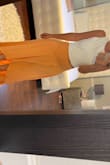 I love this skirt. It has such a comfy beach vibe and I received many compliments on it. It is quite long in the back and had to wear it with wedges in order for it to not drag. It is a viscose material so might arrive wrinkled. A quick iron run through and you're good to go. For my first one I ordered the sage color in medium. It was a little loose so I bought the orange in small. - Chris M.