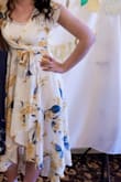 This dress was perfect for my bridal shower, which was lemon/citrus-themed! I received so many compliments! I loved how it was shorter in the front and longer in the back and the tie around the waist, it was very flattering. While it fit perfectly in the back/shoulders, I ended up needing to wear a white cami underneath because I felt like I was popping out. My only complaint about this dress is that even with the built-in underlay underneath it was still see-through. Overall very happy with my purchase! - Alyssa M.