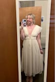I absolutely love this dress! I was nervous about the front V because it is more revealing than anything else I have ever worn. I ordered this dress in both a medium and a large. Lulus' sizing told me I would be a medium but I Was skeptical so I got both. I am glad I got the large! I am tall and have a fairly wide ribcage and the medium, while it fastened, was very tight around the ribs and hard to breathe in. The large was much more comfortable around the waist. However, this posed a new problem. I am not a well-endowed girly and if I shrugged my shoulders, the top of this dress just completely fell off. The medium fit better in the top but I had already decided to return it because it was so tight. After some tinkering with the clothes-hanger loops on the large as an experiment, I decided to get some ribbon that matched the dress and add a tie at the top of the back of the dress across my shoulders. This should keep it up just fine! I am looking forward to wearing this dress to take engagement photos! - Brittany V.