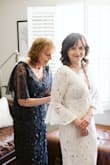 The dress fit amazing right off the hanger and with a few alterations to the design it was perfect! I shortened the bell sleeves to about half the length, closed the slit and added a bustle. - Crystal H.