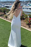 Our bride chose to put us bridesmaids in white for her wedding. This dress was extremely impressive, especially for the price point. It was exactly what I envisioned - both classic (white, detailed buttons down the back), modern (thin straps and the low back), and simple (the neckline with small lace detail). This fit me quite well and hugged in all the right places! I suggest ordering the downsize if you're on the fence - I ordered an XS instead of a Small & was very happy! I have a shorter torso so the straps would've been too long w/a S (material didn't lay flat where straps and bodice meet, but no biggie with long hair). XS was plenty long on 5'1" frame + heels (may want to alter). Material was plenty thick (quality), but you may want to wear seamless undies/thong or shapewear. No trouble with a backless "sticky" bra - 36B/34C. This dress worked well for me, but white isn't too forgiving by nature so I'd recommend for fit frames because of the form fit of this dress. - Michaela J.