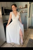 I got this dress for my outdoor wedding in September. It fits absolutely perfectly! It's a few inches too long for me, but I think heels might fix that. This dress is beautifully made, it looks very high-quality. It is bright white which I love! The skirt is flowy & the slit is not too revealing! I was worried because I thought I would need to find a bra with an open back, but I don't think I need one at all. I'm so excited to get married in this dress! - Abby J.