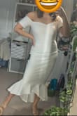 I love the top of this dress. It is very snug and true to size. The top is very flattering, however the waist and hip area were on the bigger side for me. There are no zippers or anything so you have to put the dress on from stepping in. The fabric is thick but slightly see through with the white color. I wish there was a shorter version of this pretty dress. - Ann L.